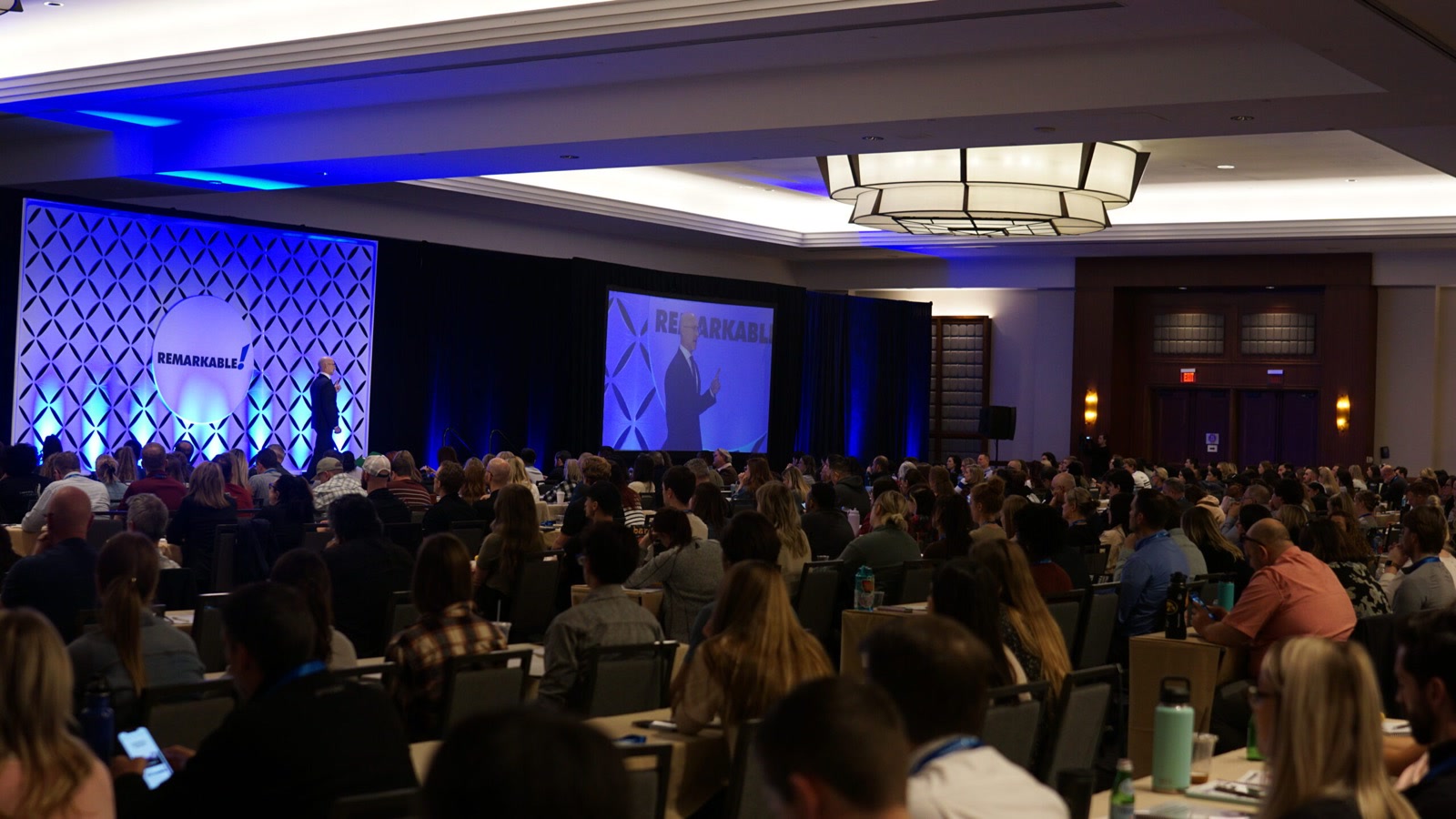 A packed room watching Dr. Stephen Franson on the Remarkable stage